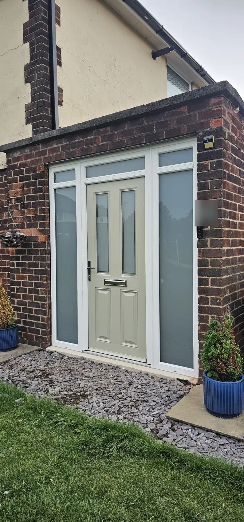 Sage green composite front door with frosted side panels installed in Romiley, Stockport