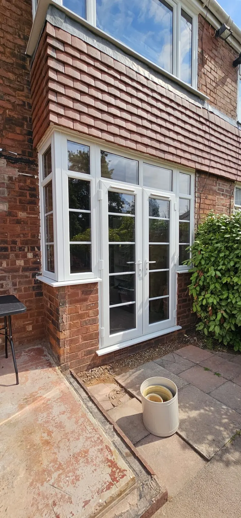 White uPVC French doors and windows fitted across the back of a house in Edgeley, Stockport