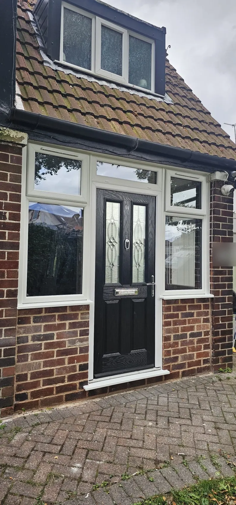 New uPVC porch with black composite door and decorative glass in Cheadle, Stockport